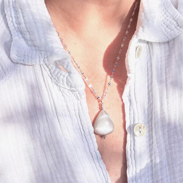 Collier pierre de lune porté par une femme, bijou raffiné.