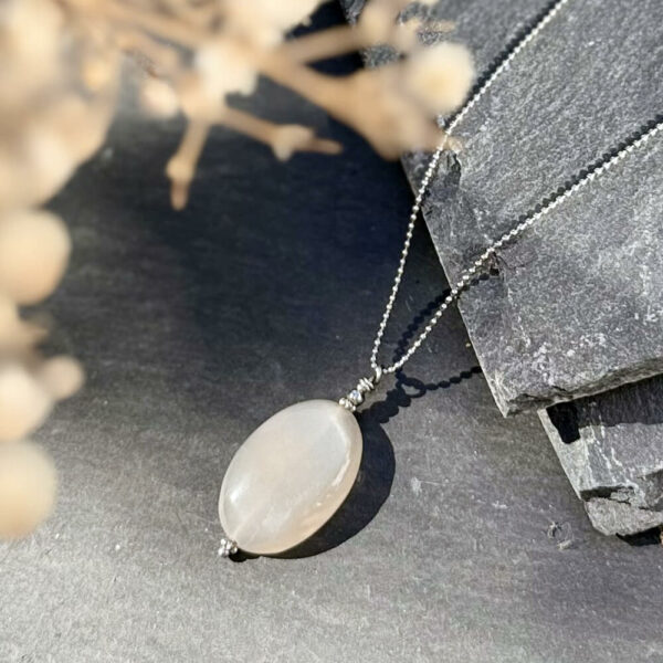 Collier en pierre de lune photographié de face.